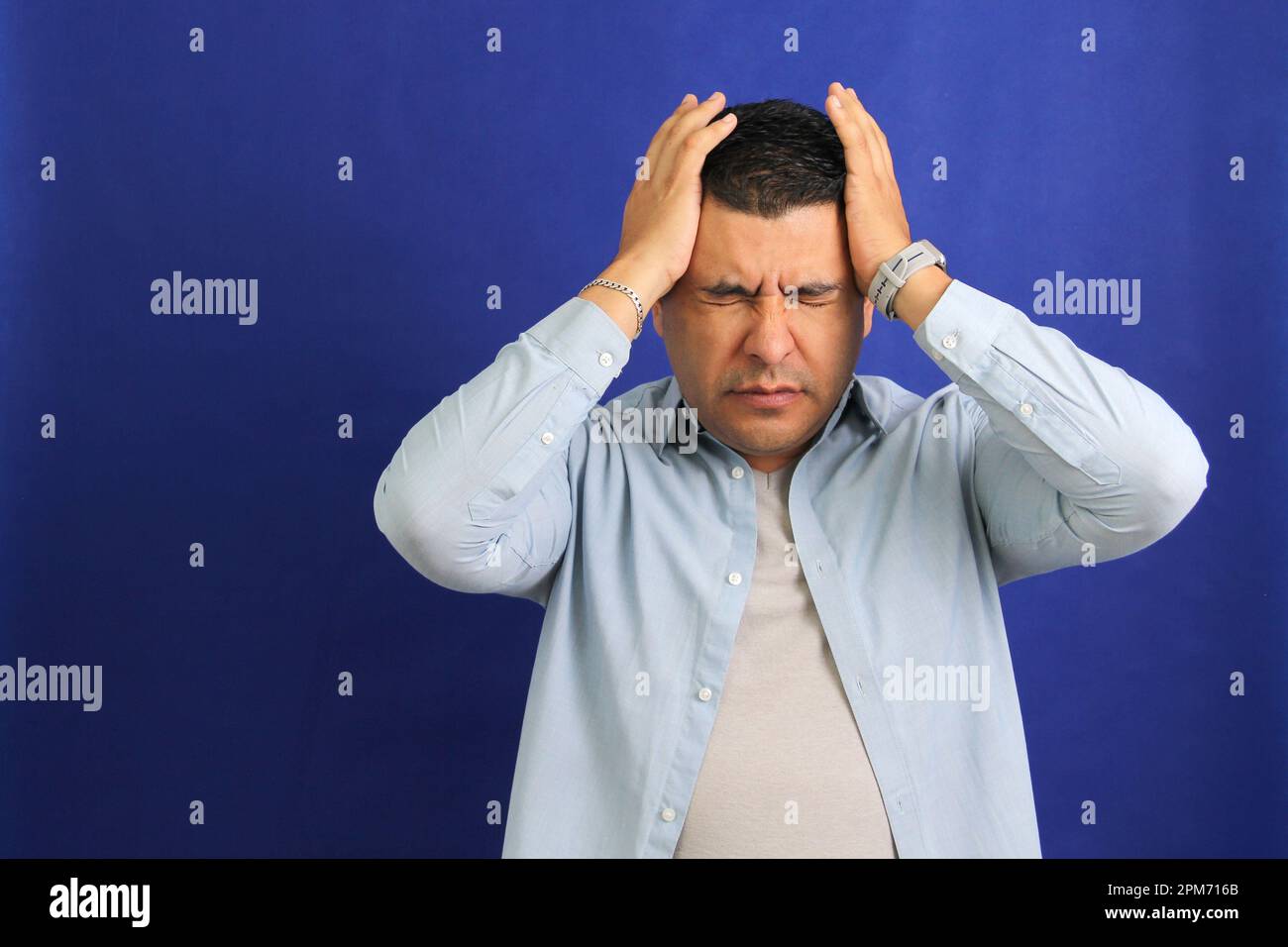 Forty year old brown latino adult man suffering from migraine disease