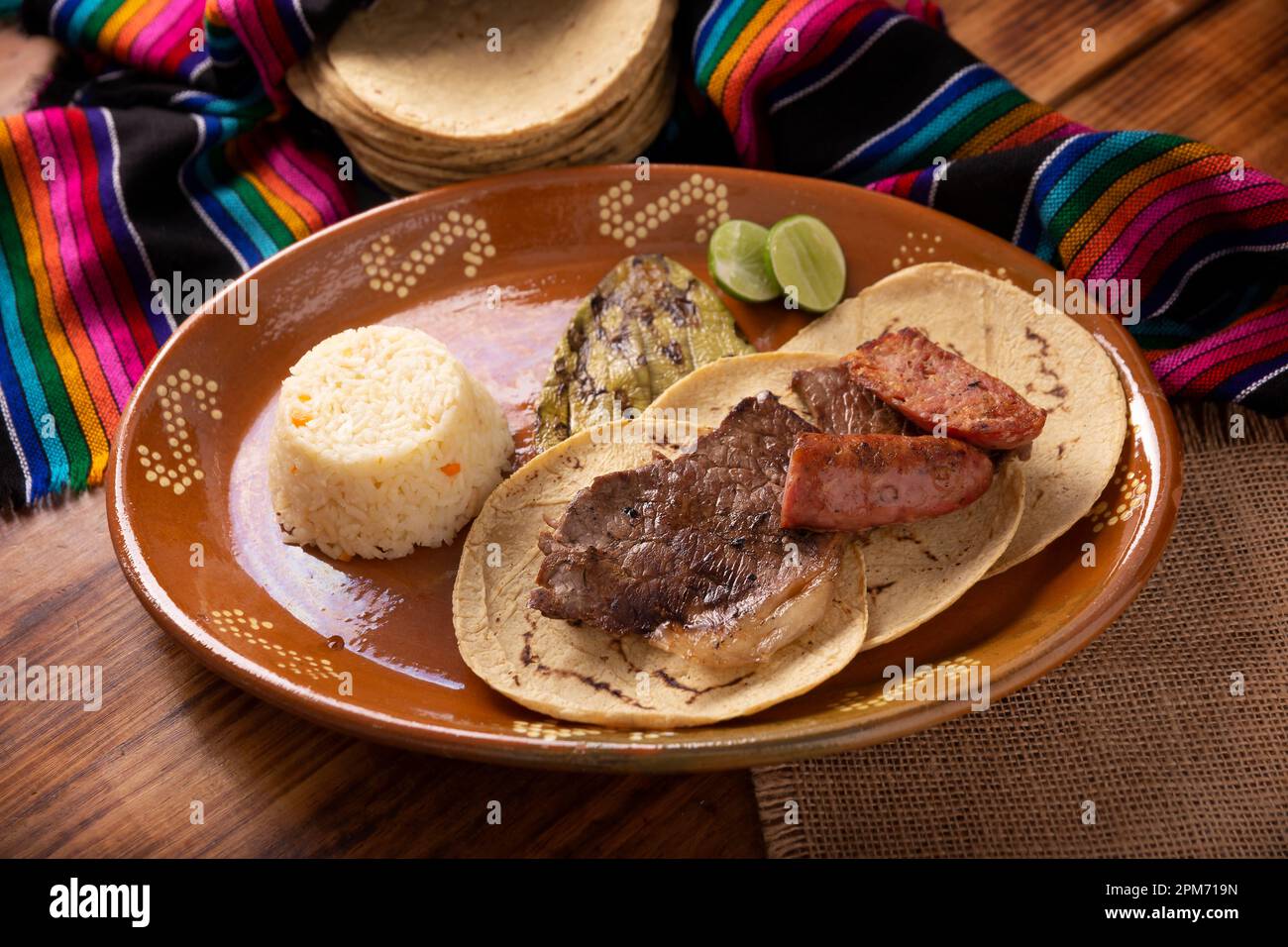 Roast meat (carne asada) very popular dish in northern Mexico, also called Asado, Discada or Parrillada, is a cooking technique in which food is expos Stock Photo