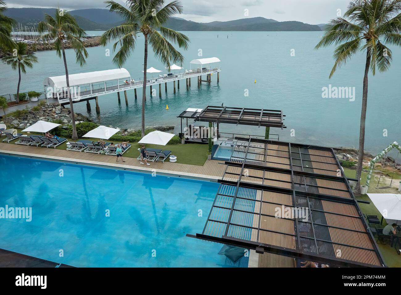 Airlie Beach, Queensland, Australia - April 2023: Looking down onto the pool, jetty and landscaping at Coral Sea Resort Stock Photo