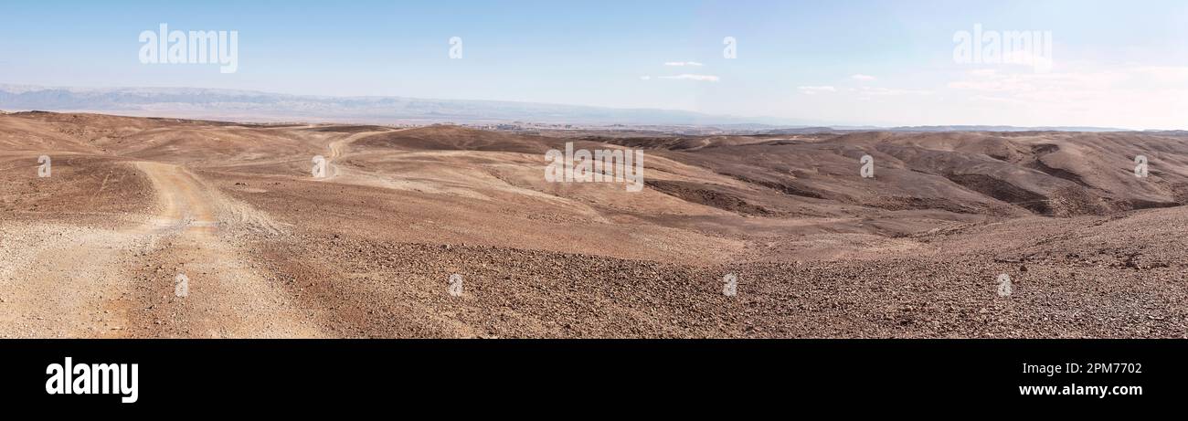 extra wide panorma of an extremely arid desert area in the Arava region of the Negev Desert in Israel with the Syrian African Rift and Jordanian mount Stock Photo