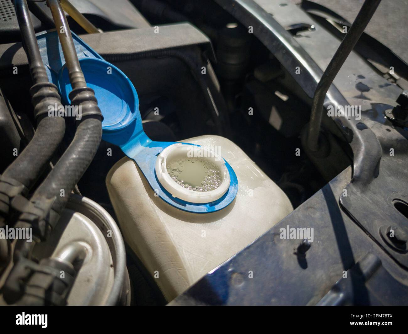 Filling water in car washer tank. Lid taken off Stock Photo