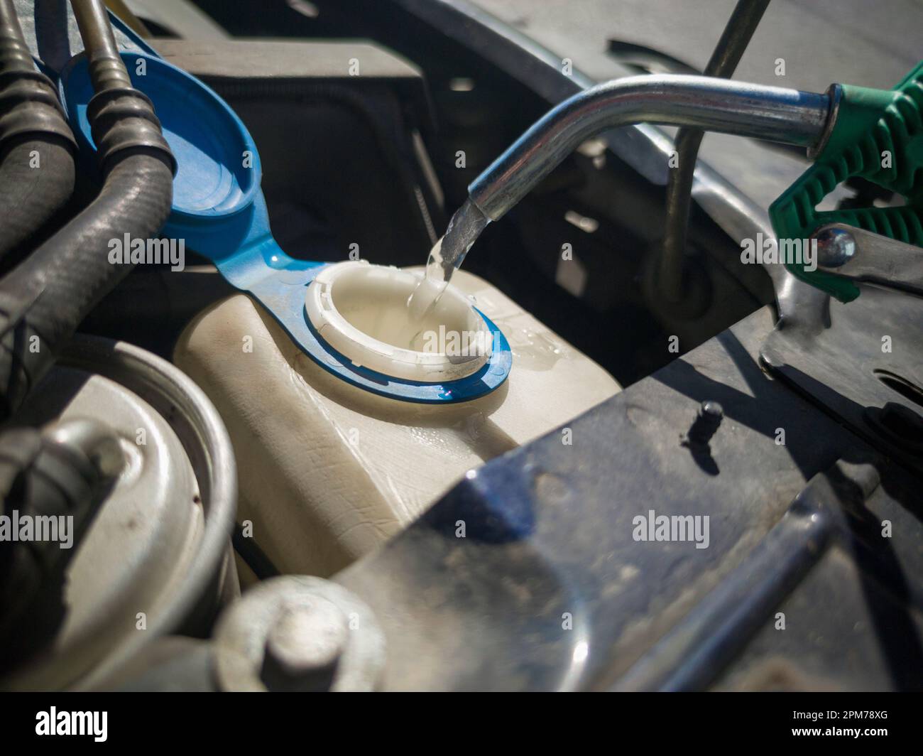 Filling water in car washer tank. Filled with water directly with a hose Stock Photo