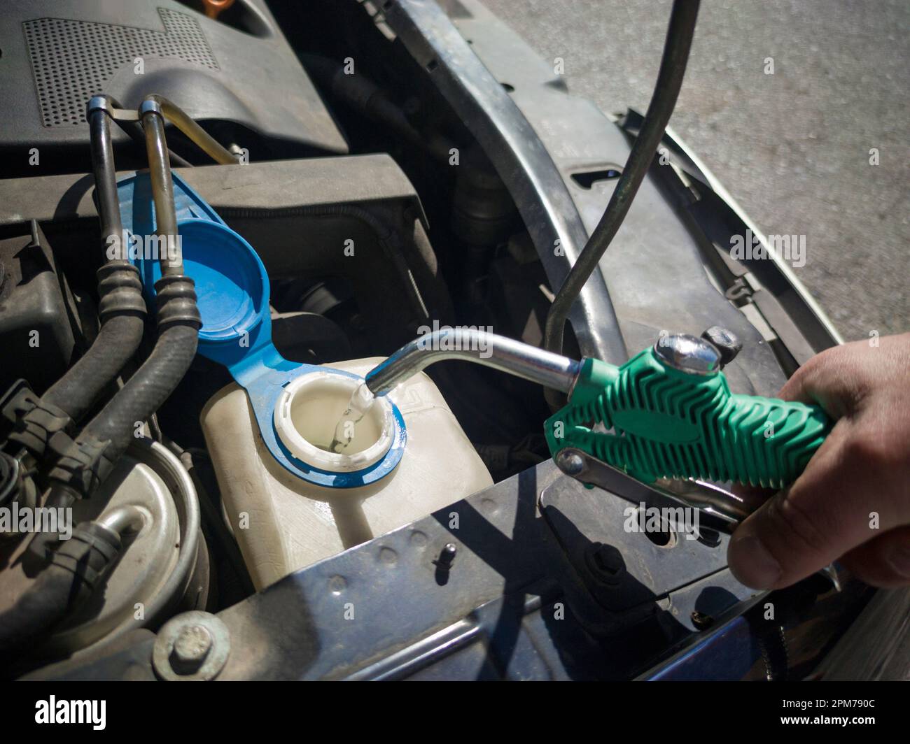 Filling water in car washer tank. Filled with water directly with a hose Stock Photo