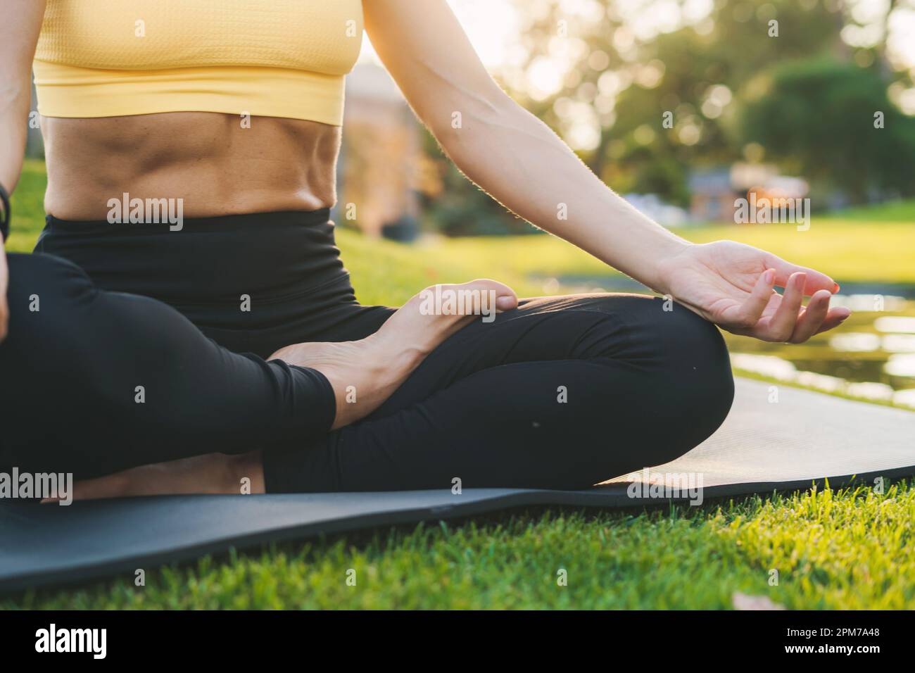 Close-up of a woman performing yoga postures at sunset sitting on yoga mat  in the morning. Yoga body posture. Training workout. Fitness woman Stock  Photo - Alamy