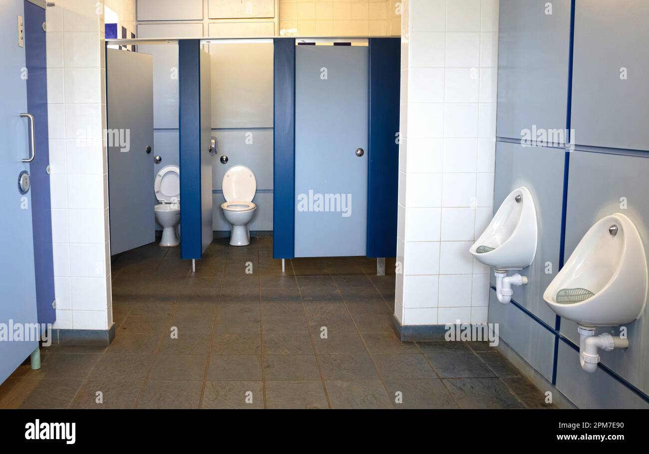 Public toilet with cubicles and urinals, empty Stock Photo Alamy
