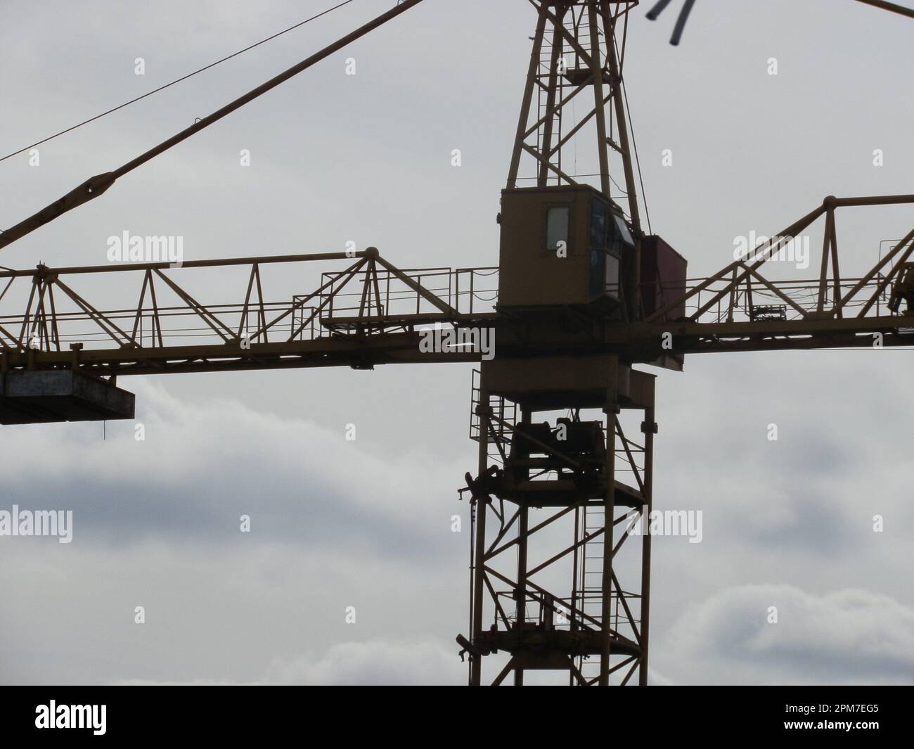Metal crane tower for the construction of the multi-storey buildings. Stock Photo