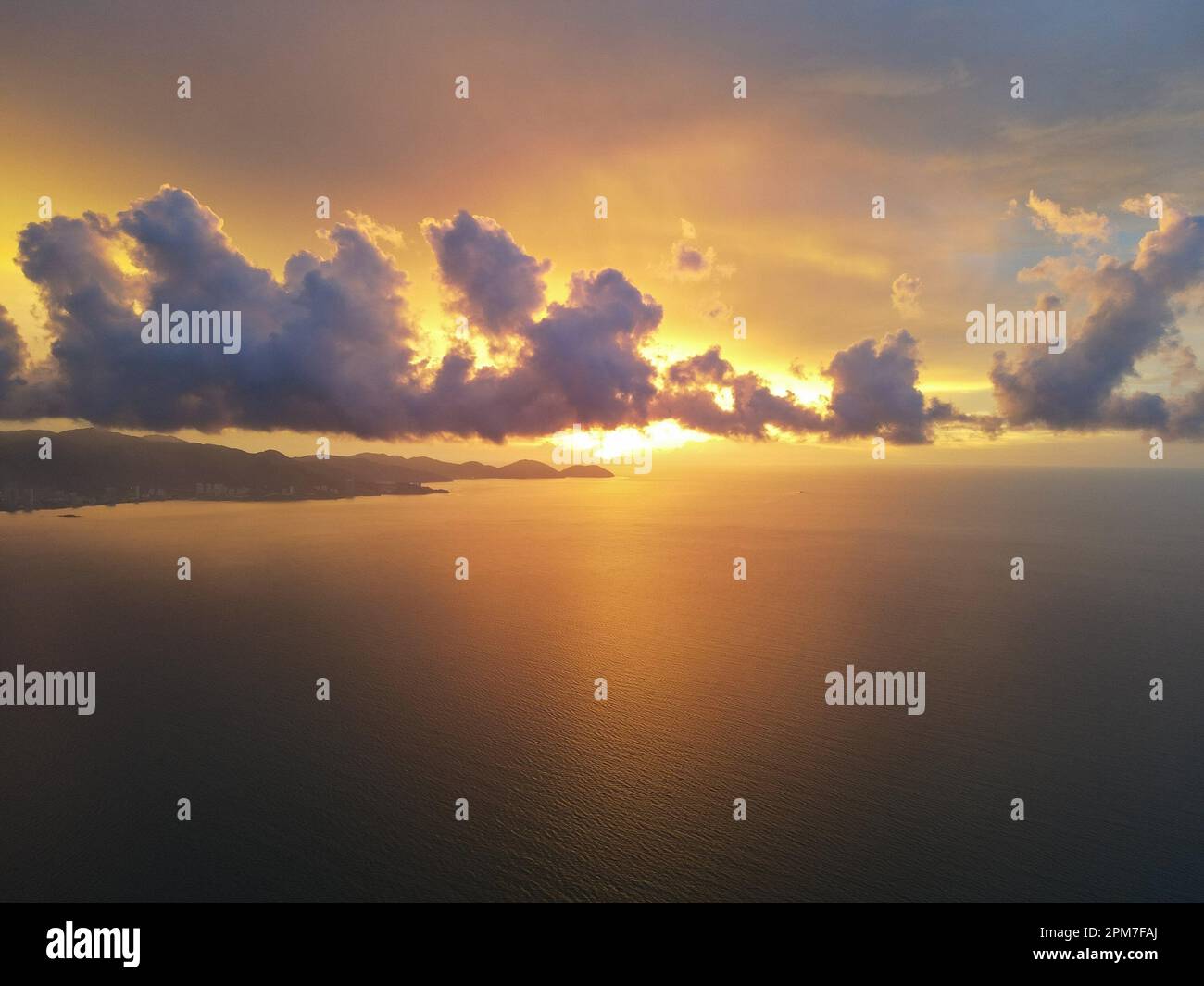 Dramatic orange color sky during sunset hour at sea. Aerial view Stock