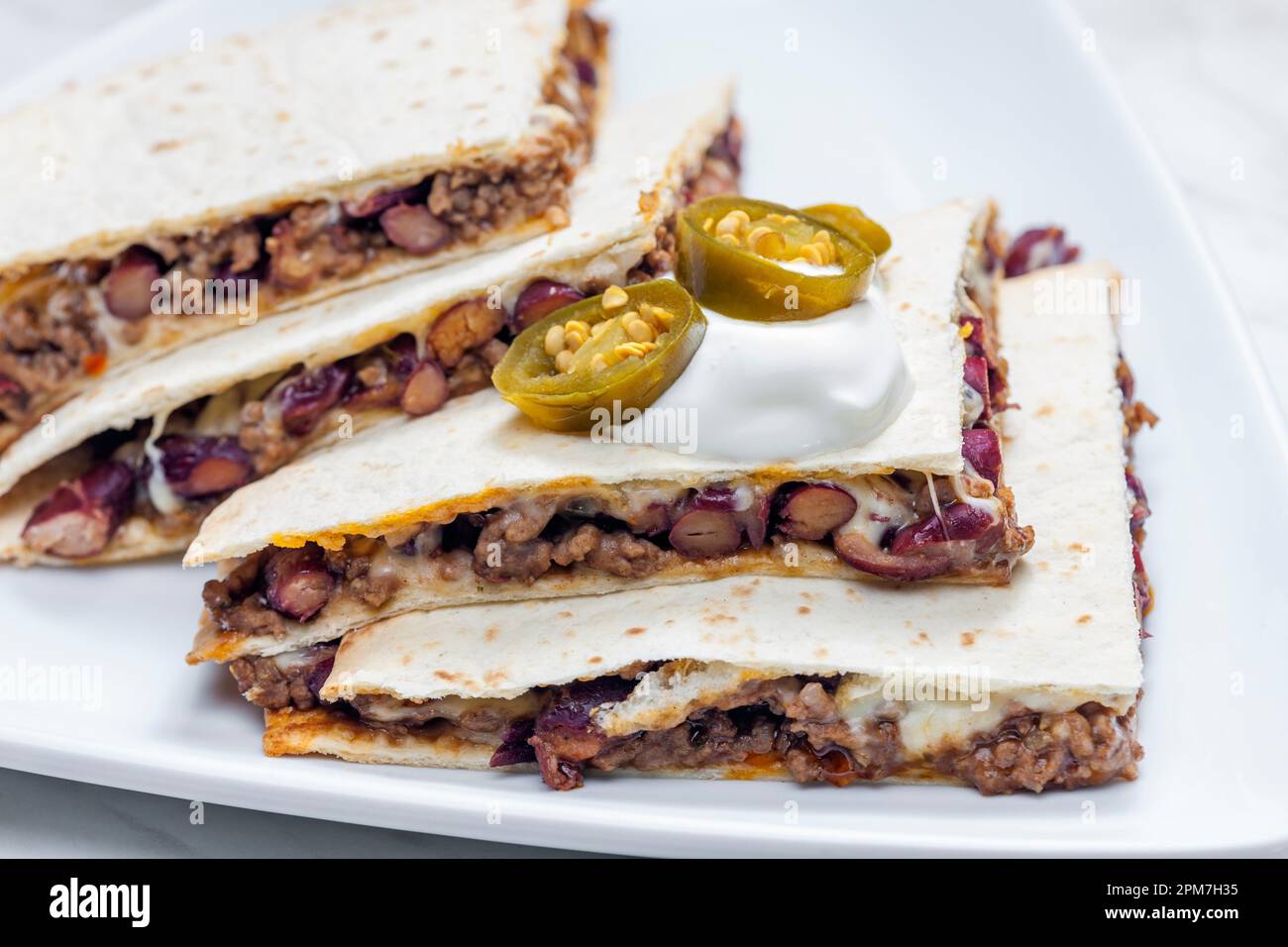 quesadilla filled with minced beef meat, beans and cheese Stock Photo