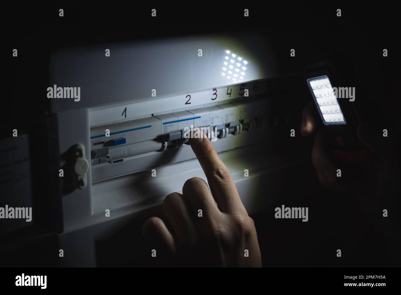 Investigate a home fuse box during a power outage. Blackout concept Stock Photo Alamy