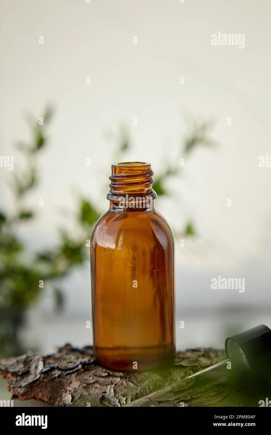 Dropper glass bottle Mock-Up. Liquid pipette oil or serum elixir, hyaluronic acid. Natural beauty treatment. Stock Photo