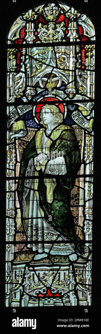 Stained glass window by Percy Bacon & Brothers depicting St John the Evangelist, St Hilda's Church, Lucker, Northumberland Stock Photo