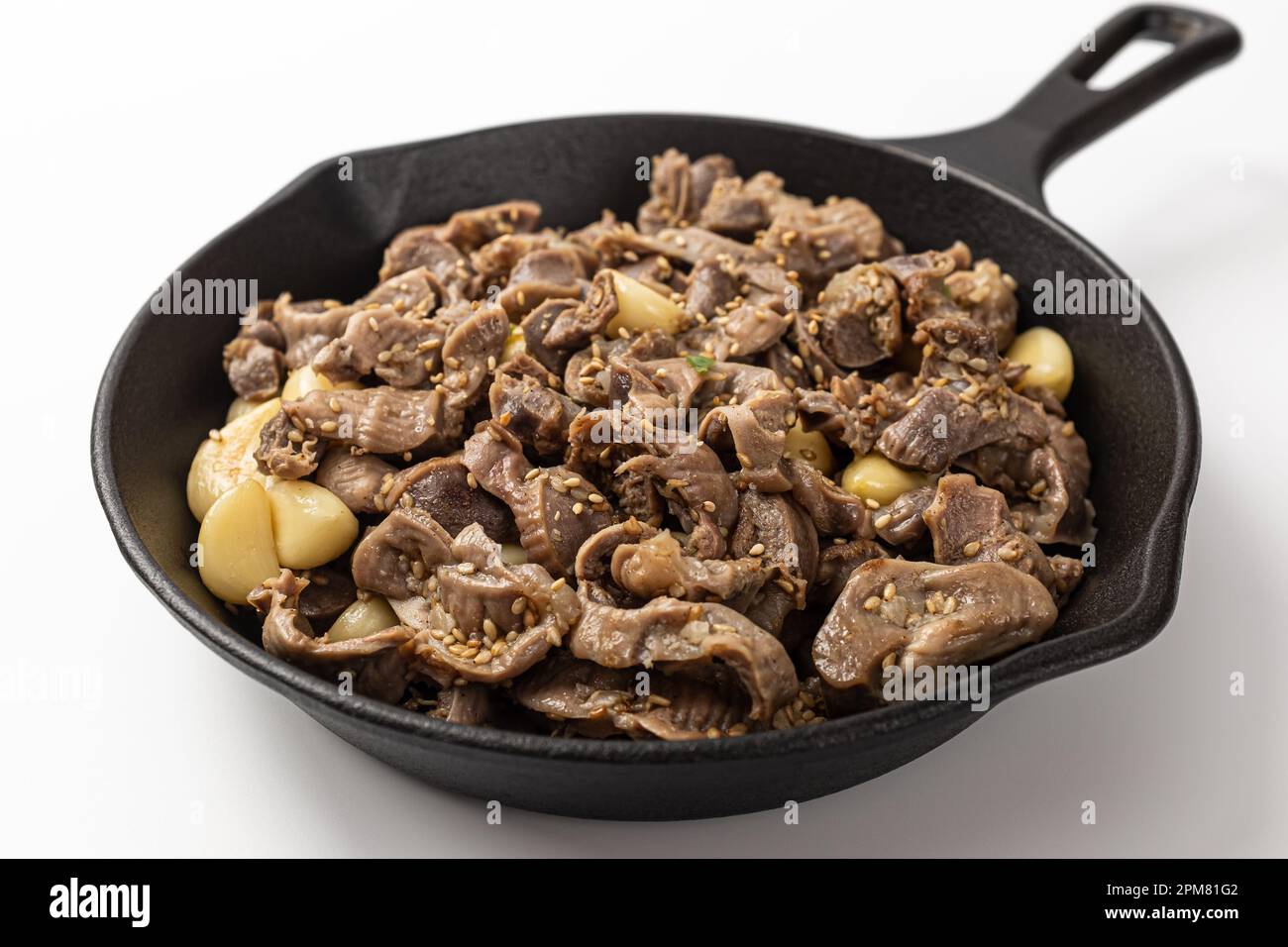 Stirfried chicken gizzards and garlic on a white background Stock