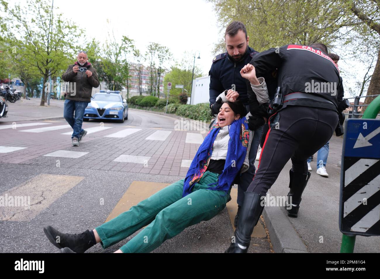 Activist Miriam Tinto of 'Ultima Generazione' is removed by law enforcement officers during a traffic blockade. Stock Photo