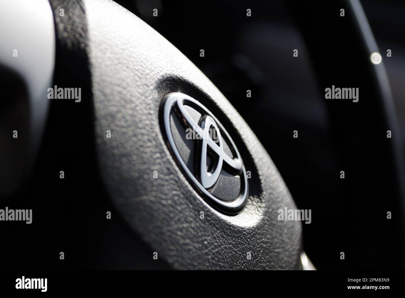 VLADIVOSTOK, RUSSIA - SEPTEMBER 24, 2012: Toyota logo on steering wheel. Selective focus. Stock Photo