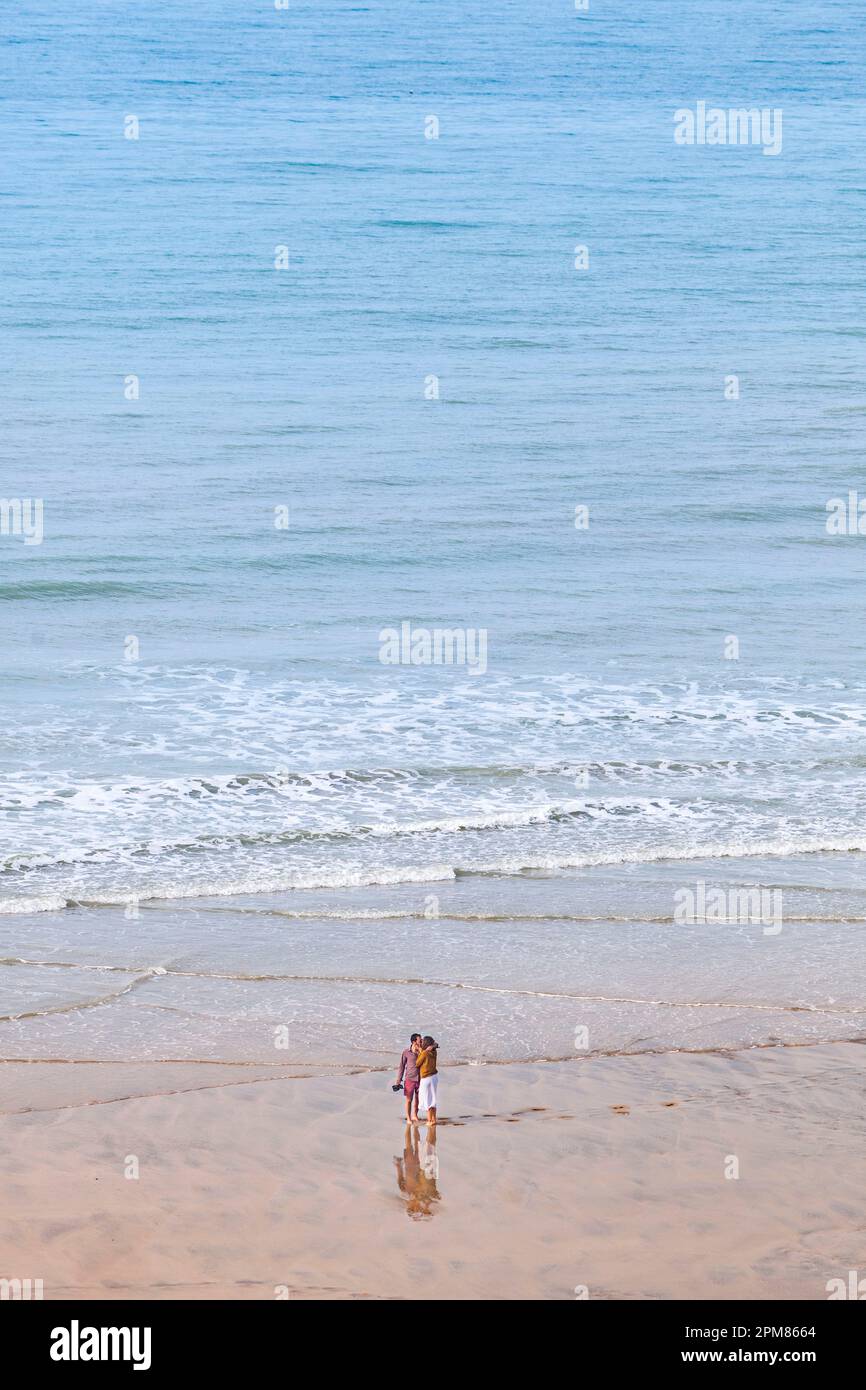 France, Seine-Maritime, Veules-les-Roses, listed as one of the Most Beautiful Villages of France, romantic scene of lonely couple kissing barefoot in the sea Stock Photo