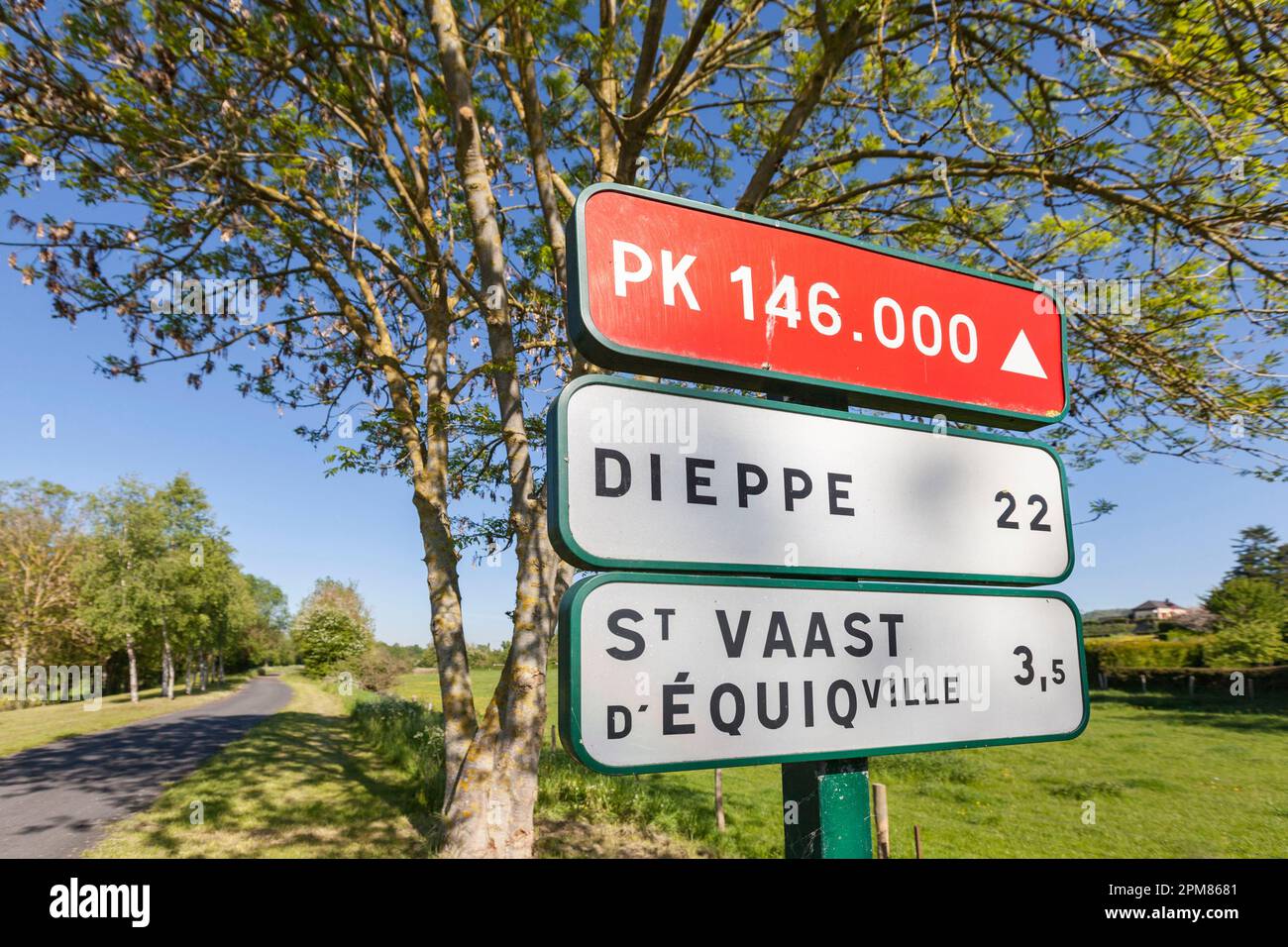 France, Seine Maritime, Pays de Bray, Osmoy-Saint-Valery, Greenway Paris-London, on the former track of the first railway linking Paris to the sea, directional signs announcing kilometric points and level crossings recall the origins of this cycle path Stock Photo
