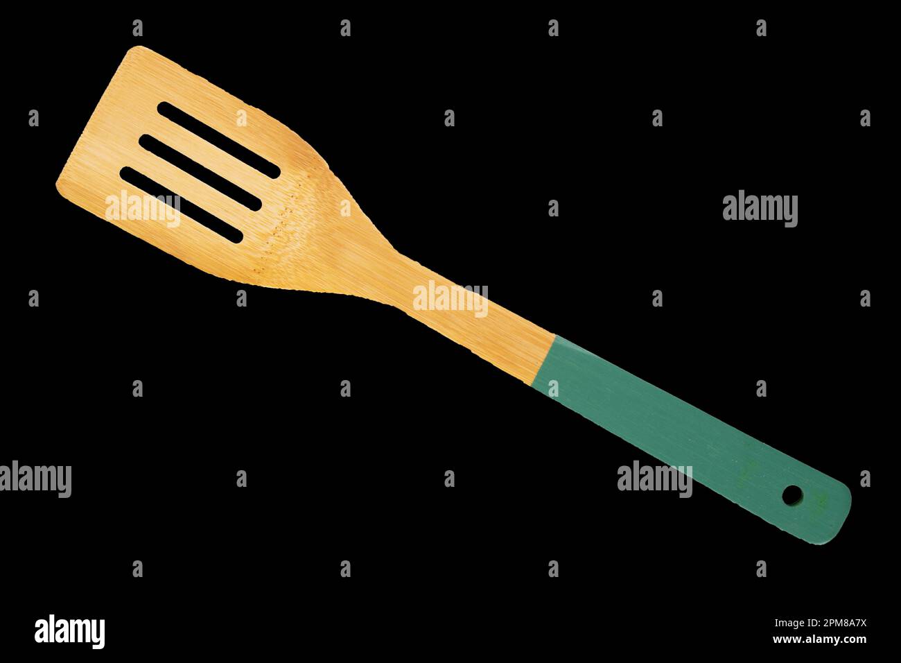 One wooden spoon for kitchen isolated on black background, macro, top view. Stock Photo
