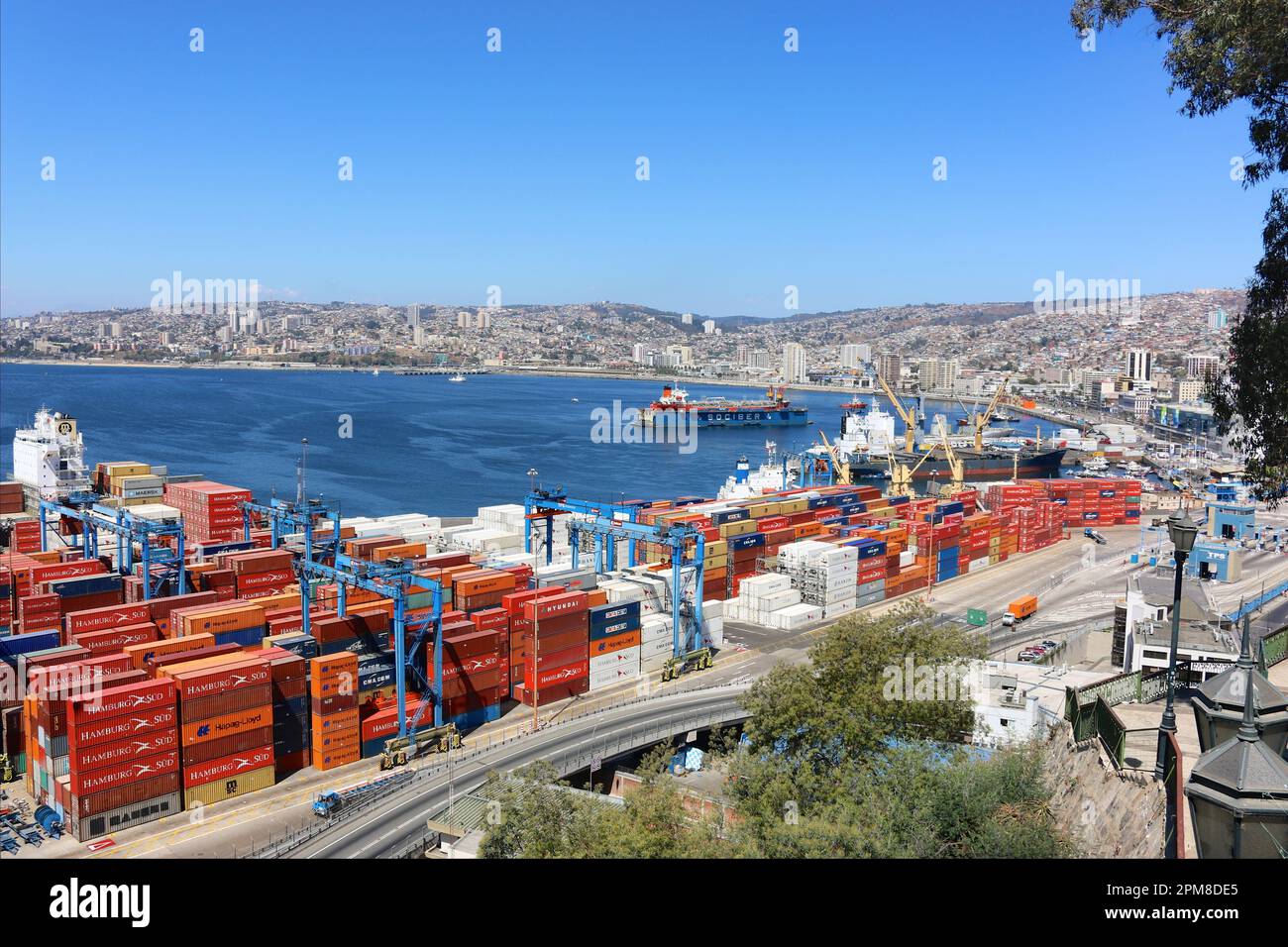 The mythical & colorful Chilean port of Valparaiso, Chile, cargo ship, container ships, industrial habour landscape, floating drydock, dry docks, bay Stock Photo