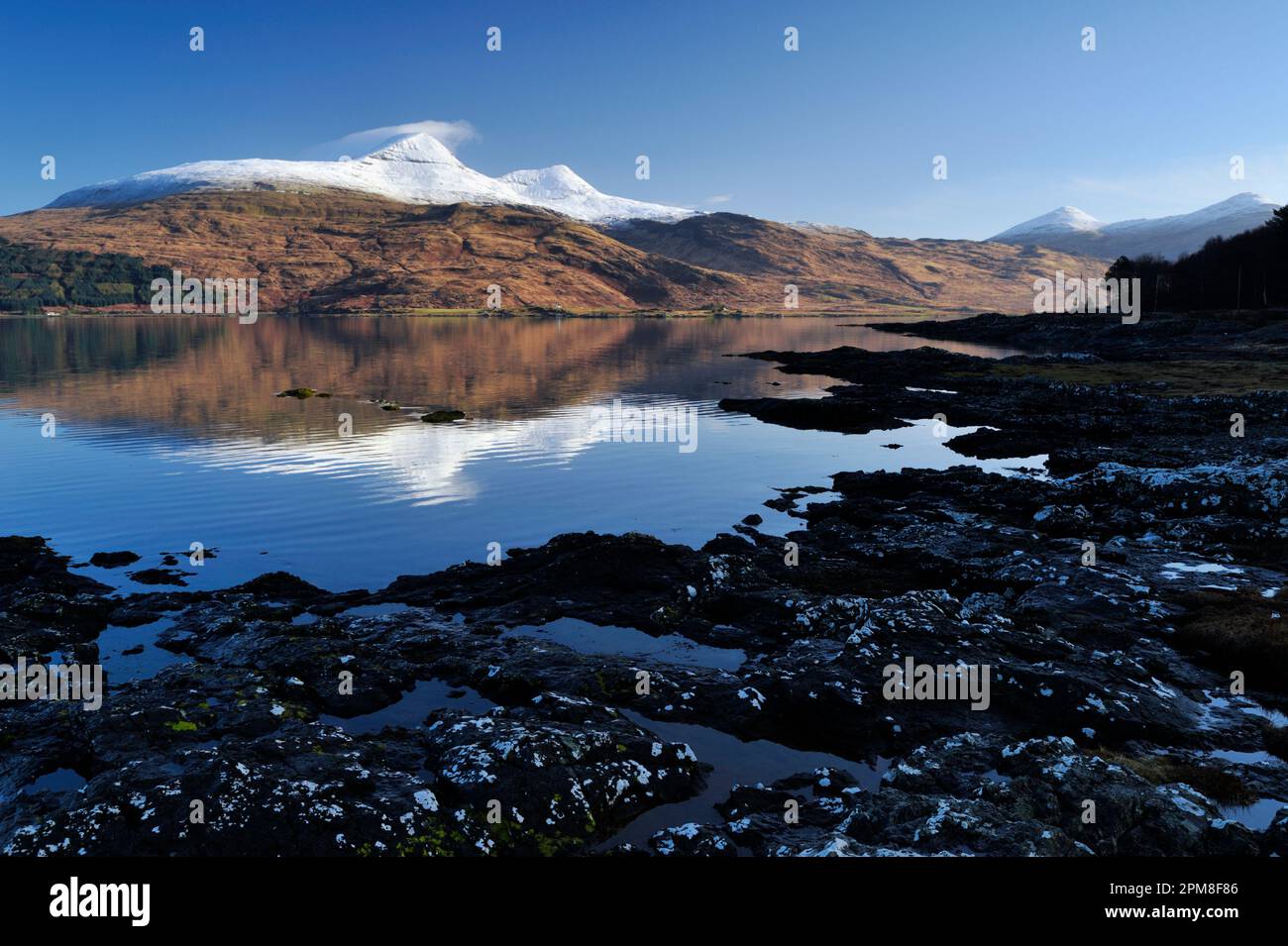 View to snow-capped Ben More on the Isle of Mull from South looking over Loch Scridain at low tide, Scotland, April 2008 Stock Photo