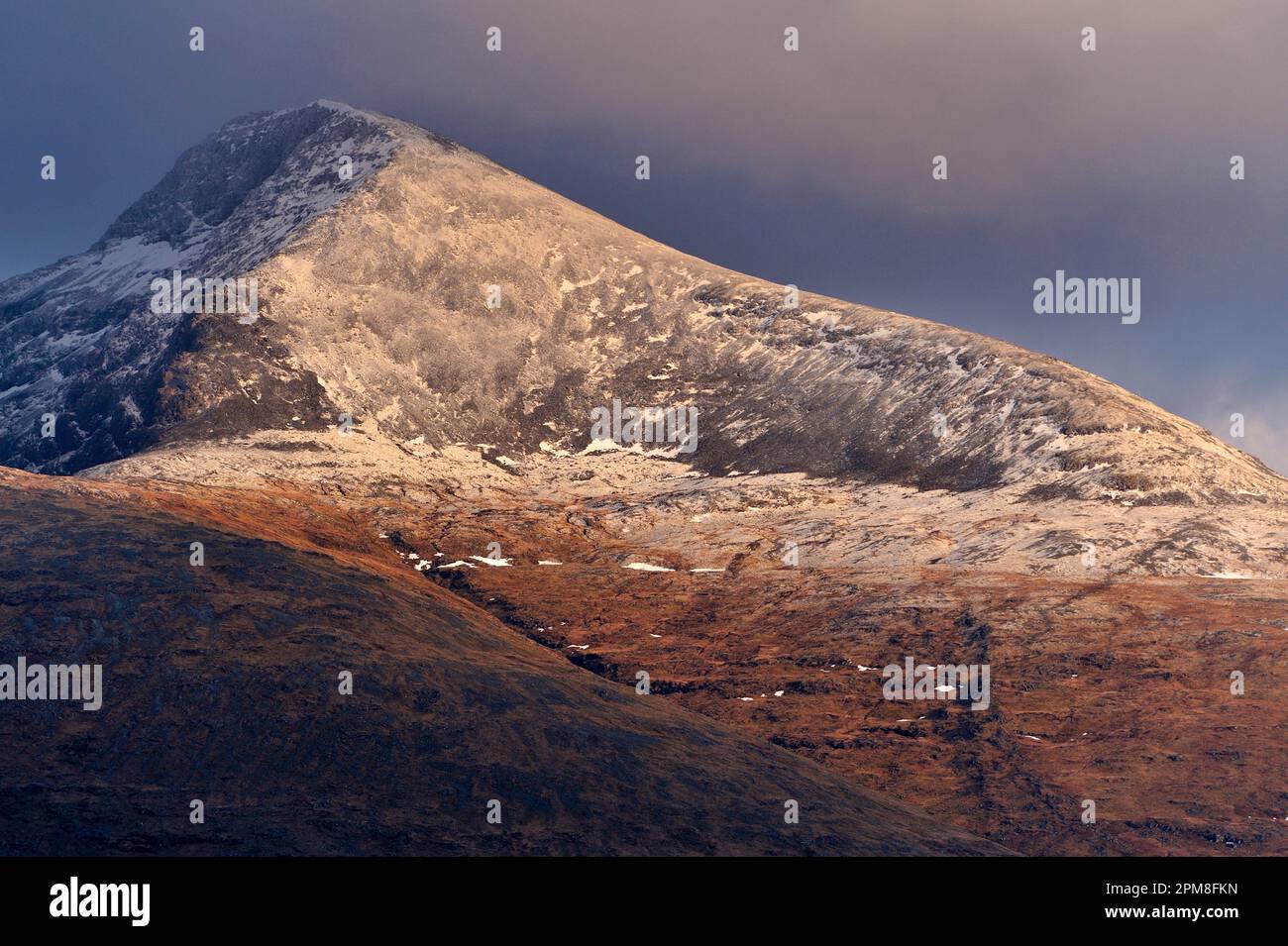 View of snow-capped mountain Ben More. At an elevation of 966m it is the highest mountain and only Munro on the Isle of Mull. Stock Photo