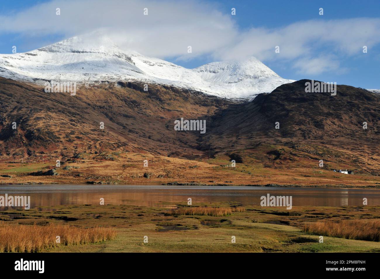 View to snow-capped Ben More on the Isle of Mull from South looking over Loch Scridain at low tide, Scotland, April 2008 Stock Photo