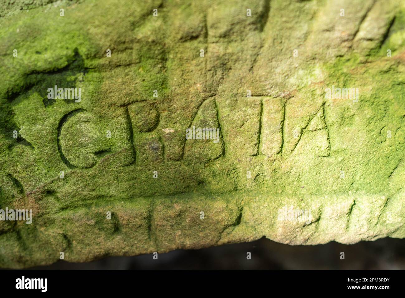 Old stone carved with the word, 'GRATIA' meaning 'thanks' on St Mary's Well, an old Christian