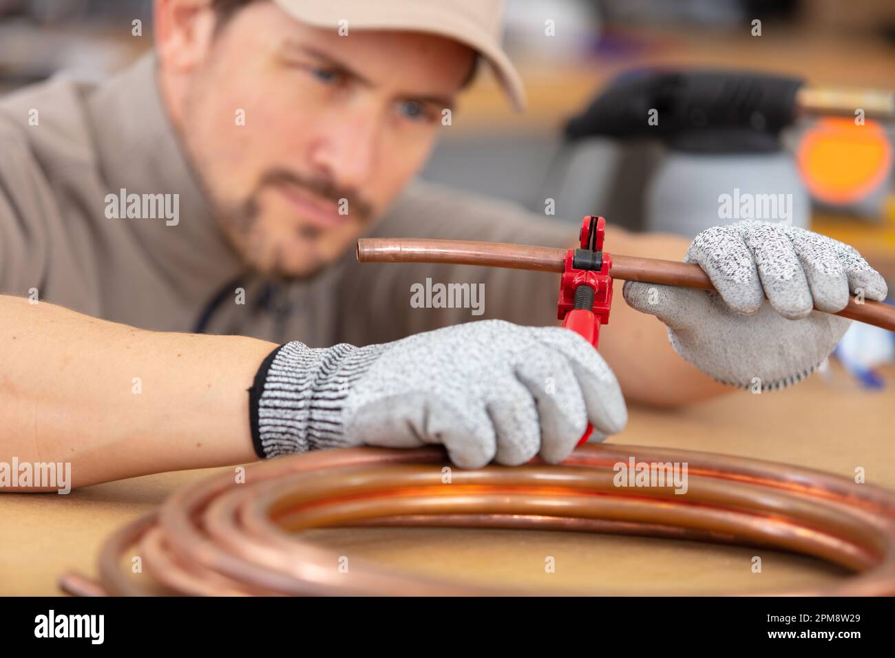 industrial plumber cutting a copper pipe Stock Photo Alamy