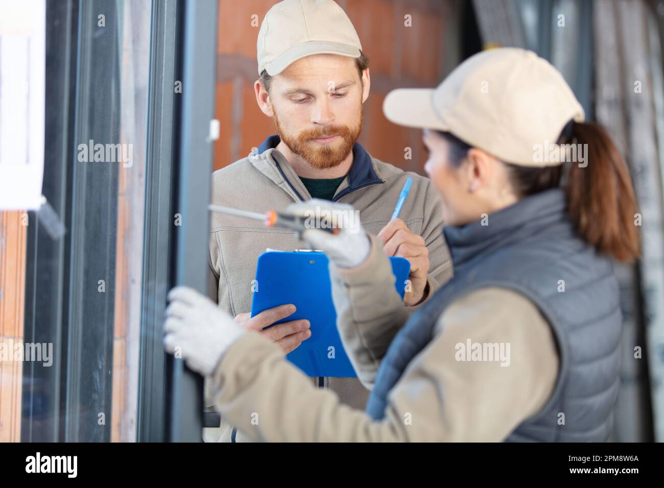 female and male builders at work Stock Photo