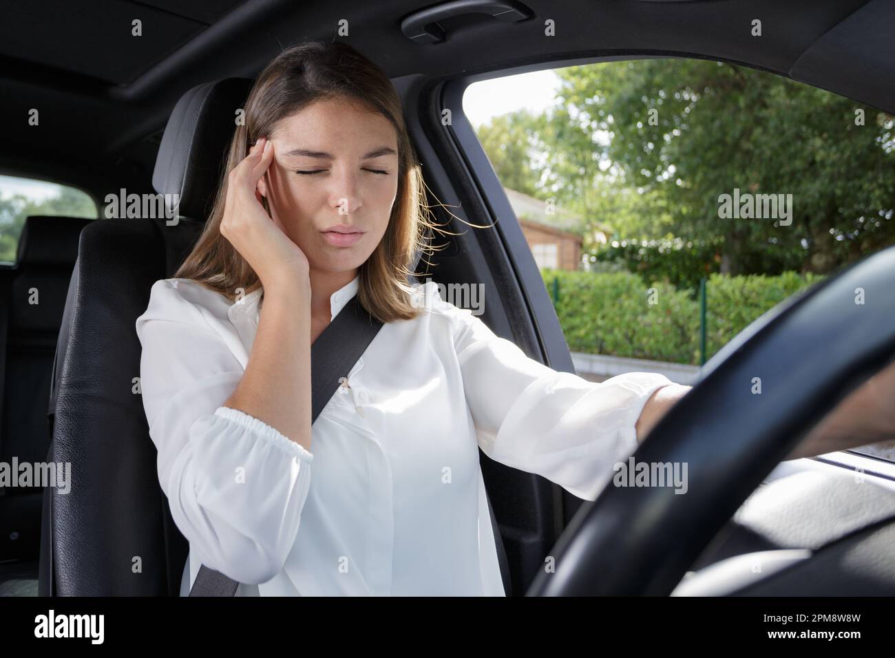 woman with headache in a car Stock Photo Alamy