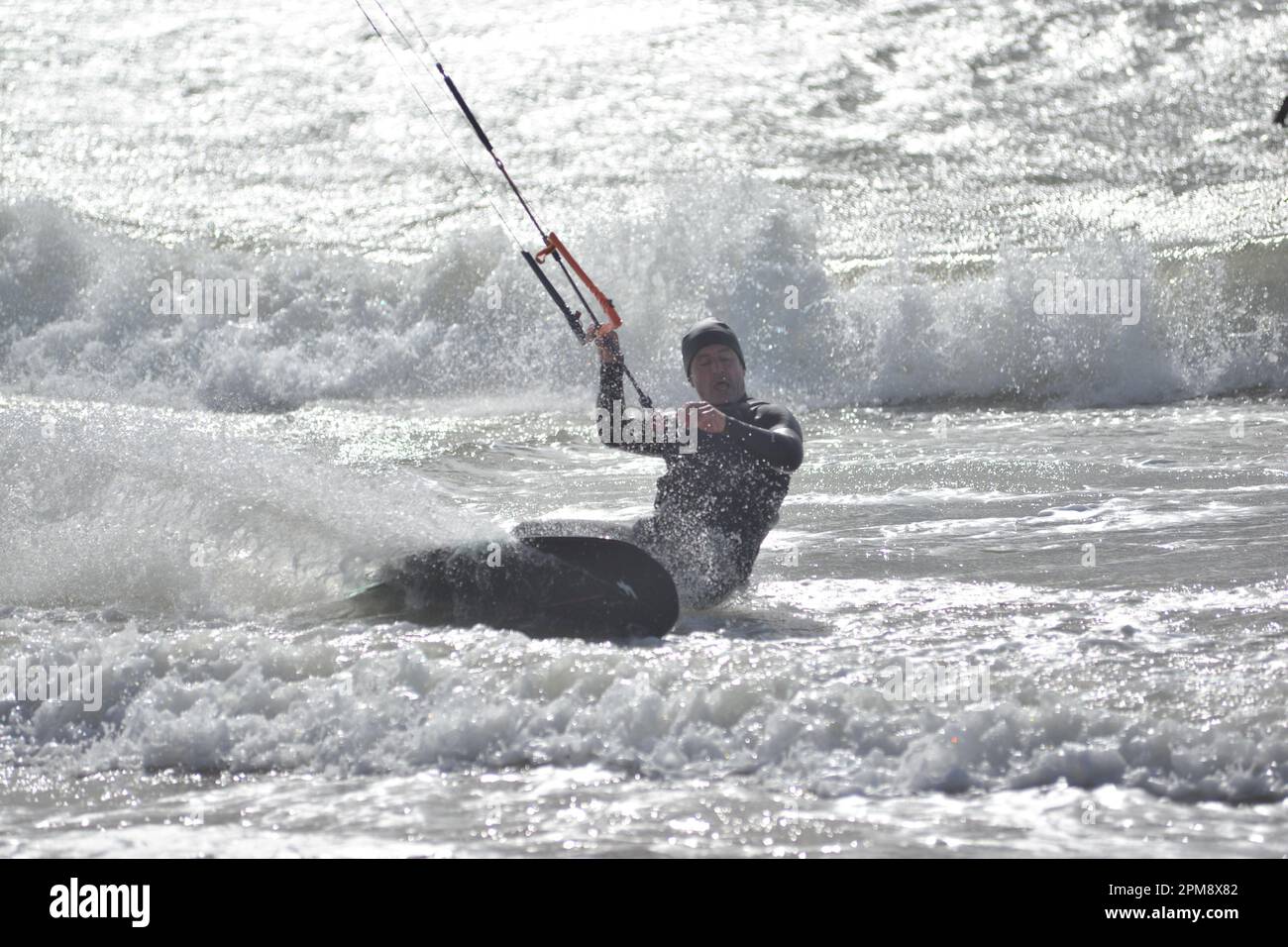 Storm Noa, Boscombe, Bournemouth, Dorset, UK, 12th April 2023, Weather. Kite surfer in strong winds and stormy conditions on the seafront in the morning. Credit: Paul Biggins/Alamy Live News Stock Photo