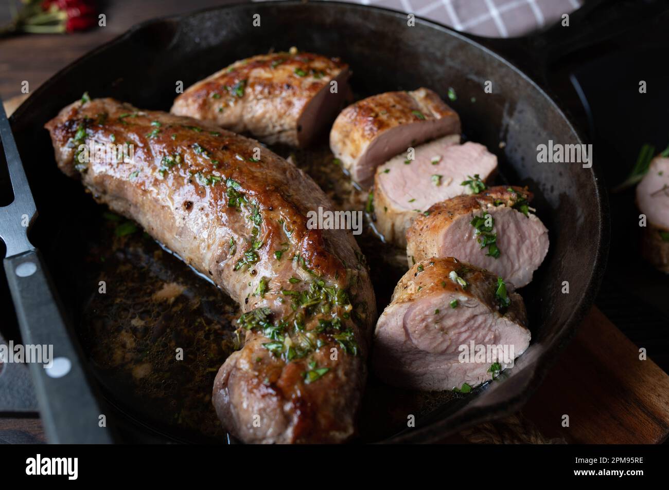 Pork fillet with herb butter in a cast iron pan Stock Photo Alamy