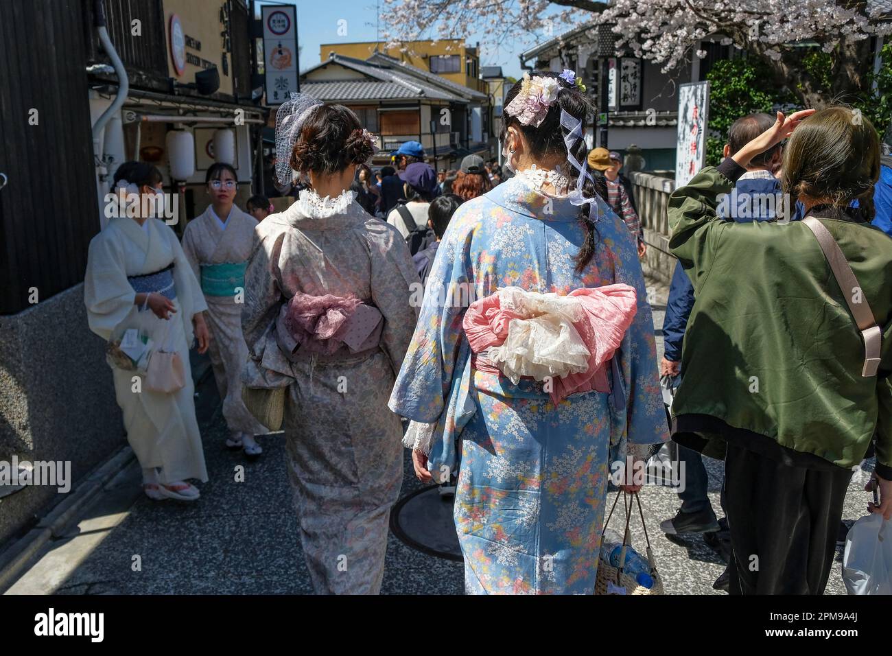 Kyoto, Japan - March 28, 2023: Women dressed in kimonos walk on Sannenzaka, a cobbled pedestrian street in Kyoto, Japan. Stock Photo