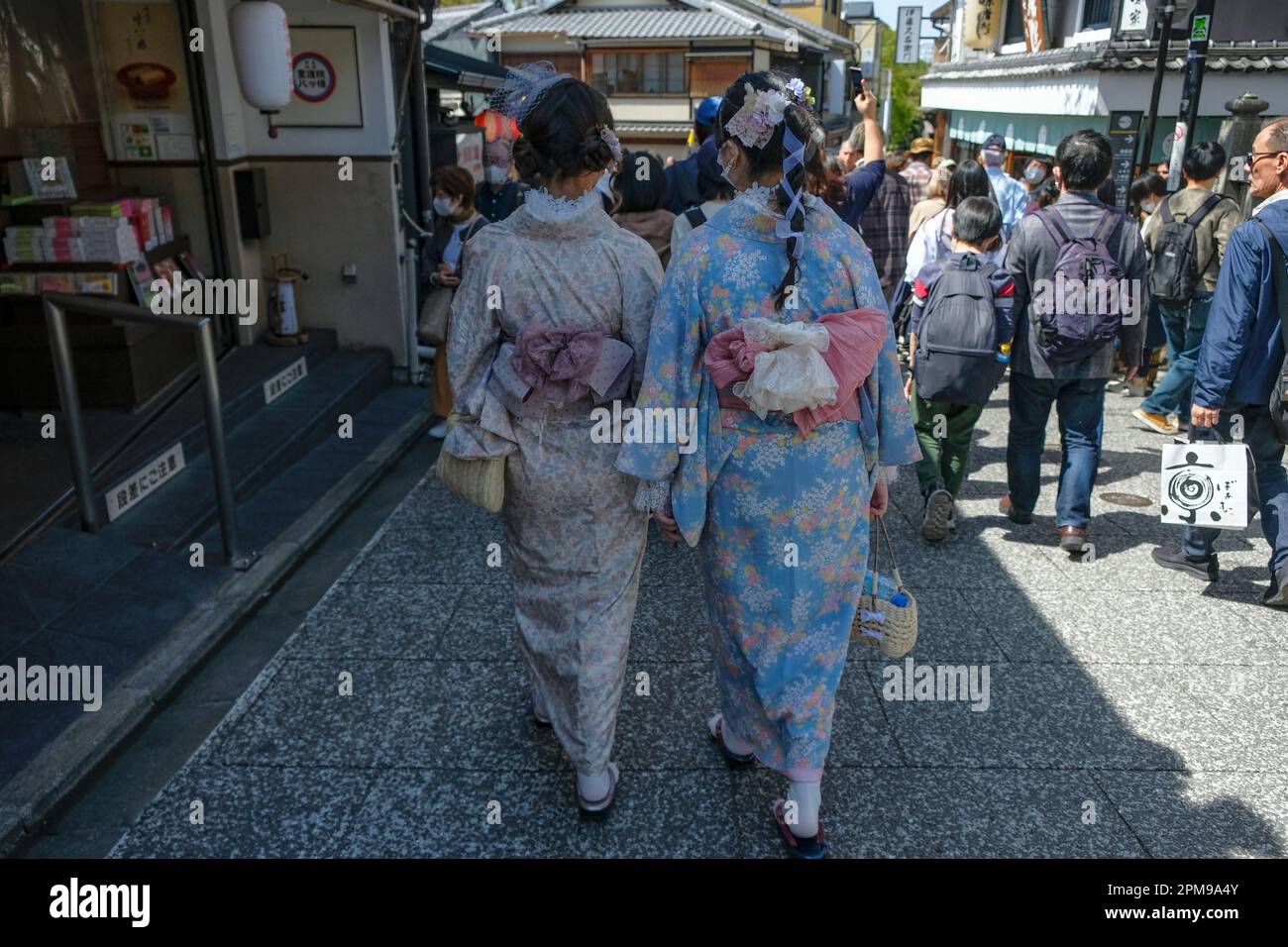 Kyoto, Japan - March 28, 2023: Women dressed in kimonos walk on Sannenzaka, a cobbled pedestrian street in Kyoto, Japan. Stock Photo
