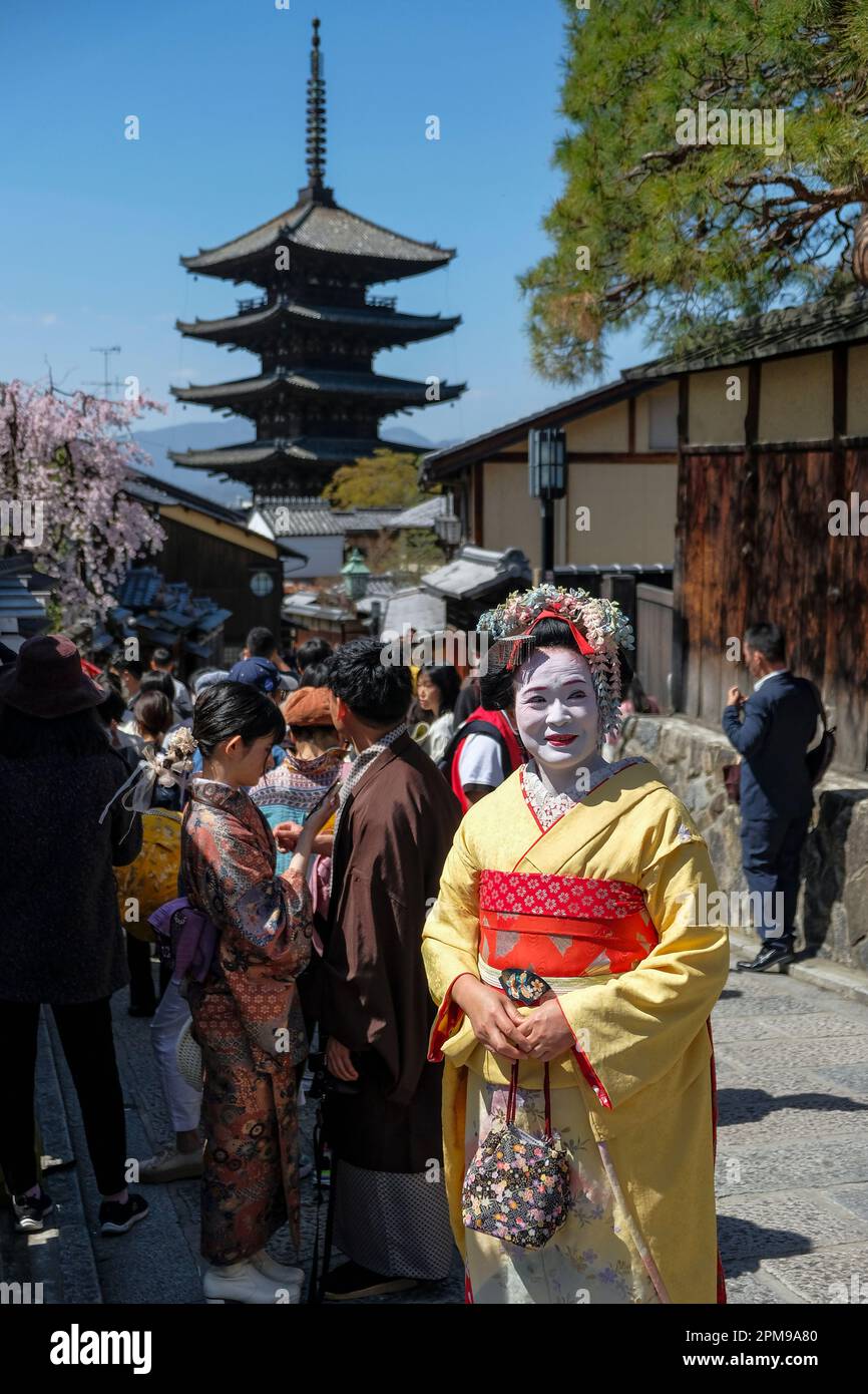 Kyoto, Japan - March 28, 2023: A woman dressed as a geisha at Sannenzaka, a stone-paved pedestrian road in Kyoto, Japan. Stock Photo