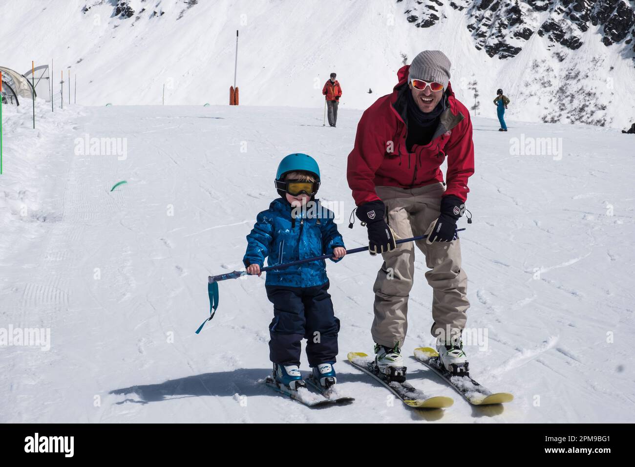 Father teaching his young son to learn to ski in the French Alps in family friendly resort of La Rosiere, France, Europe Stock Photo