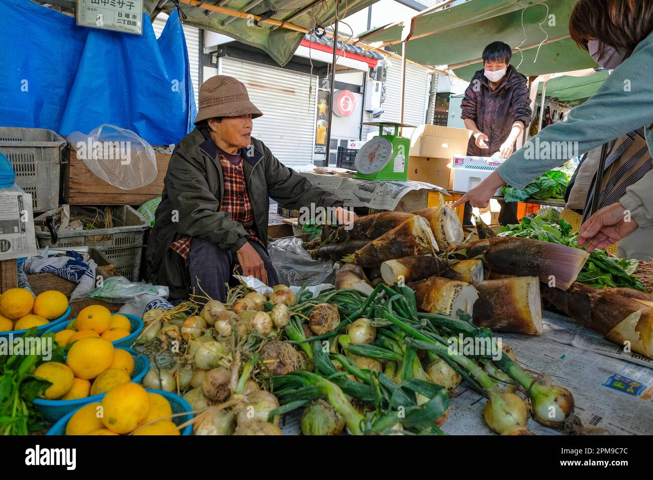 Kochi, Japan April 9, 2023 A woman selling fruits and vegetables at