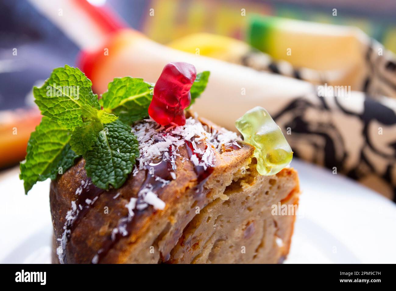 Gummy bears playing on a food table with a banana bread Stock Photo Alamy