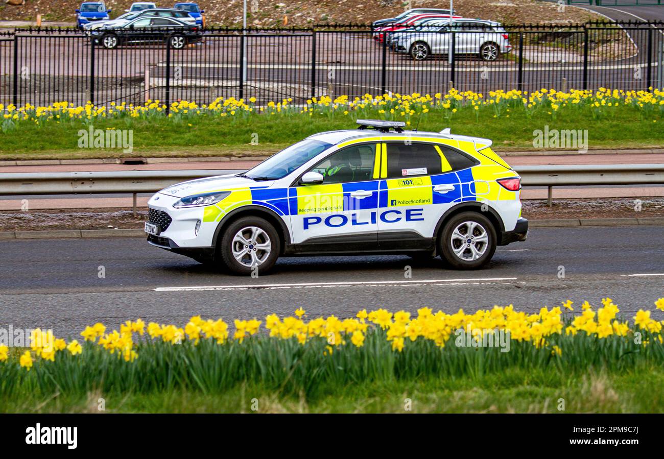 A Police Scotland police car travelling along the Kingsway West Dual Carriageway in urban Dundee, Scotland Stock Photo