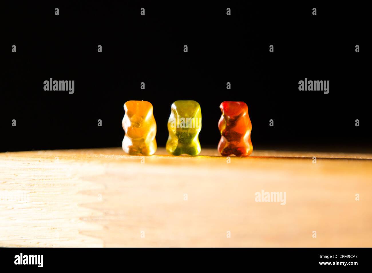 Gummy bears playing on a food table Stock Photo