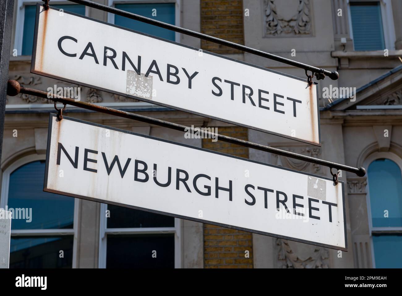 A sign for Carnaby Street and Newburgh Street. Famous tourist and shopping destination in Westminster, London, United Kingdom. Stock Photo