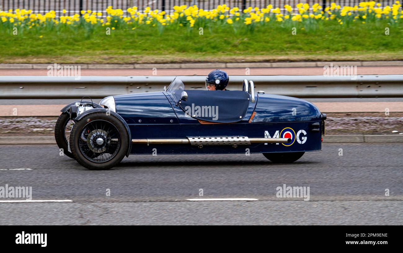 A Morgan three wheeler sports car travelling along the Kingsway West Dual Carriageway in urban Dundee, Scotland Stock Photo