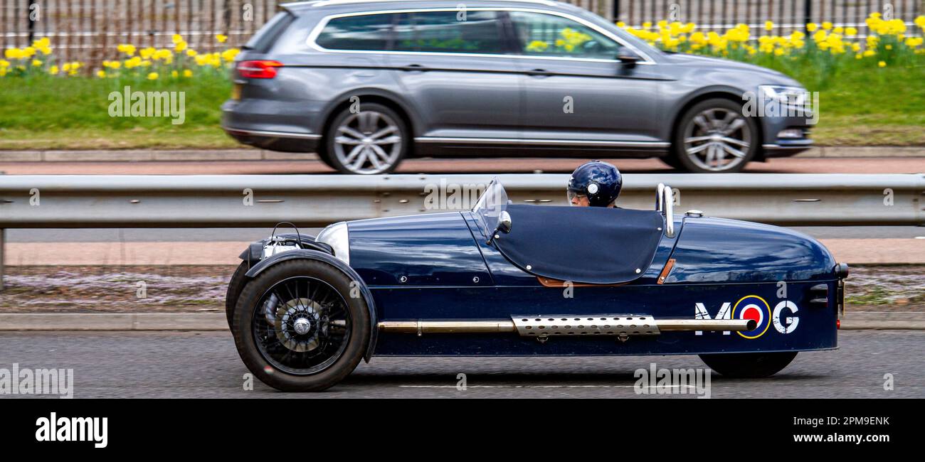 A Morgan three wheeler sports car travelling along the Kingsway West Dual Carriageway in urban Dundee, Scotland Stock Photo