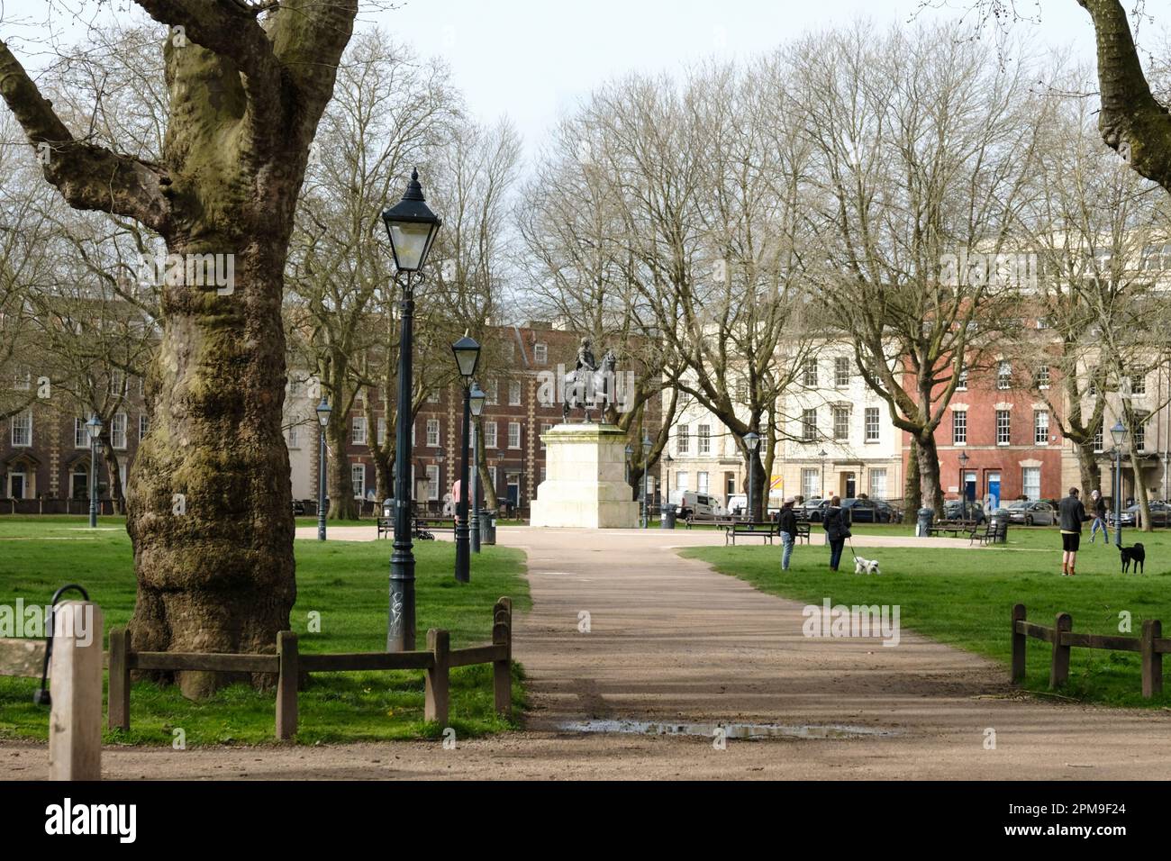 The Equestrian statue of King William III and people enjoying the park, Queen Square Bristol UK