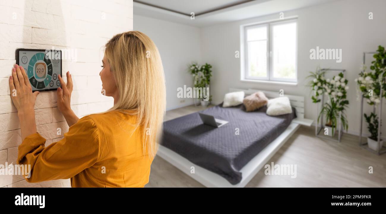 Woman using smart wall home control system Stock Photo