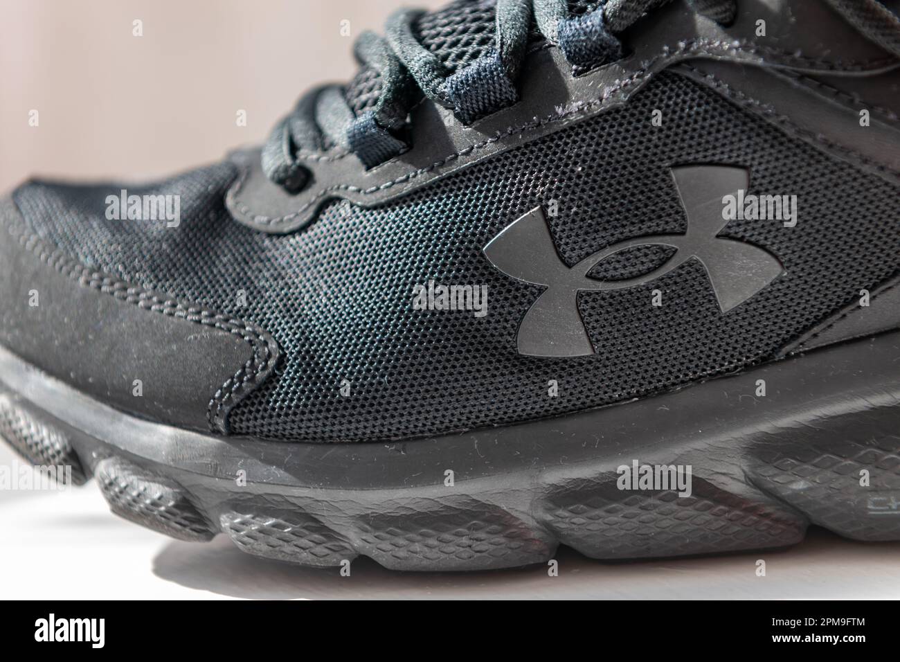 London. UK- 04.09.2023. Close up of a Under Armour running shoe showing the company logo, trademark. Stock Photo