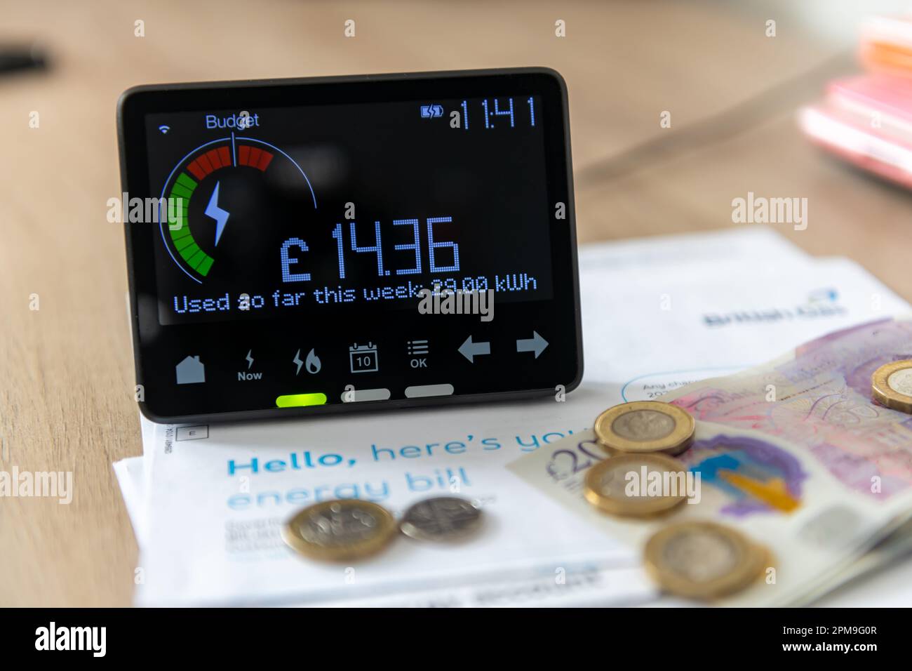 A smart energy meter on household energy bills. Cost of living, rising energy cost concept. A smart energy meter on household energy bills. Cost of li Stock Photo
