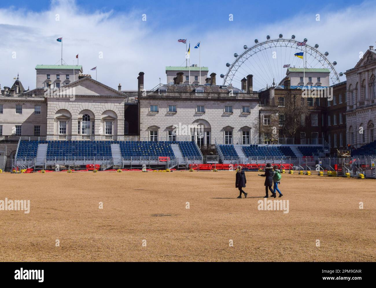 London, UK. 12th April 2023. Workers install seats at Horse Guards Parade as preparations for