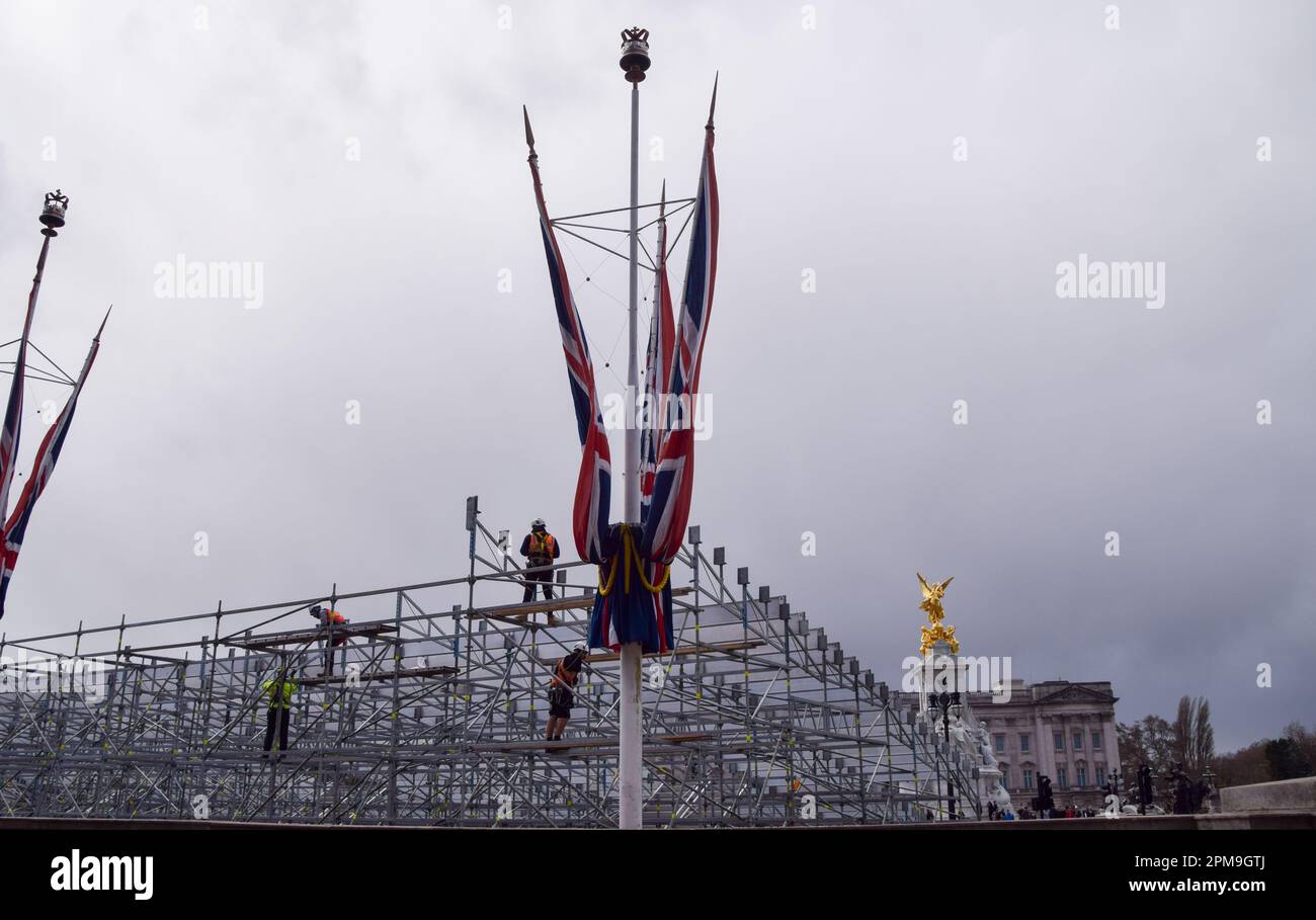 London, UK. 12th April 2023. Workers install seats outside Buckingham Palace as preparations for