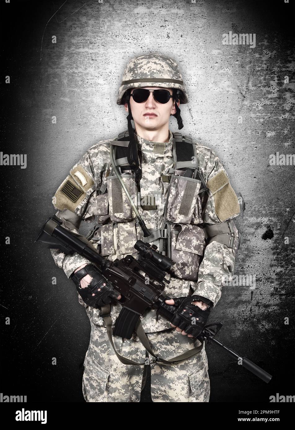 US soldier with rifle isolation on gray background Stock Photo