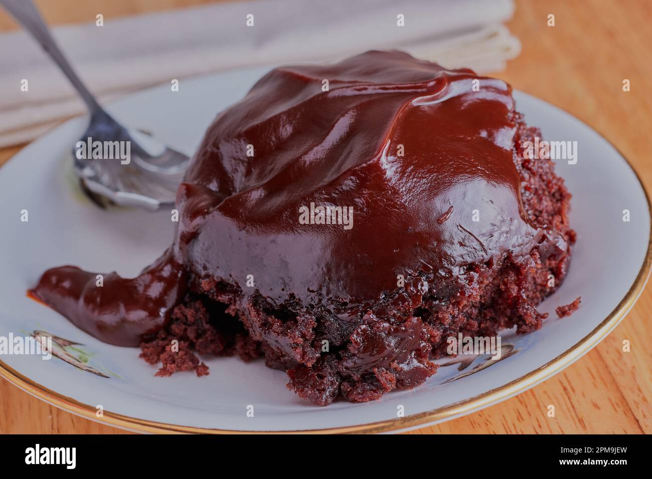 Helping of chocolate pudding on a white plate. Stock Photo